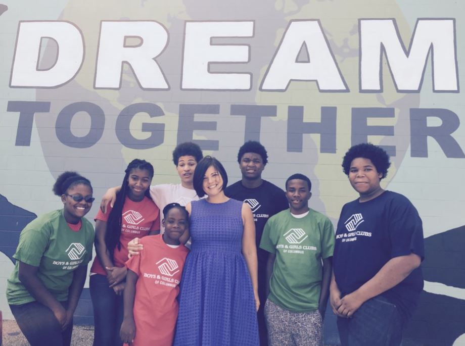 Rebecca Brown Asmo poses for a photo with a group of children during her tenure as CEO of the Boys & Girls Clubs of Central Ohio