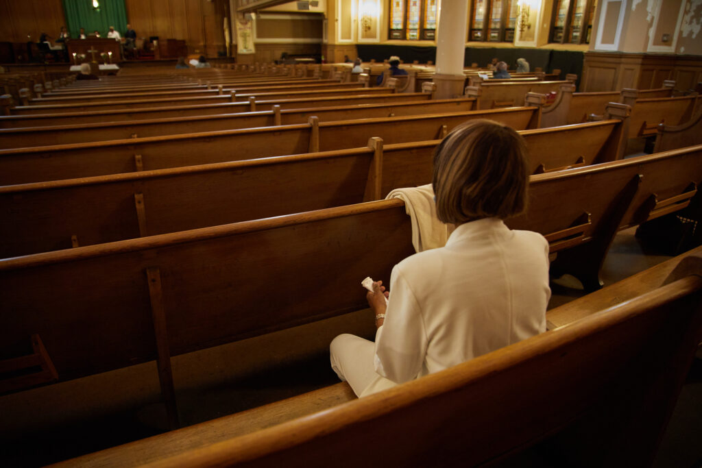 The first group of church members arrive early to select seats before Sunday service.