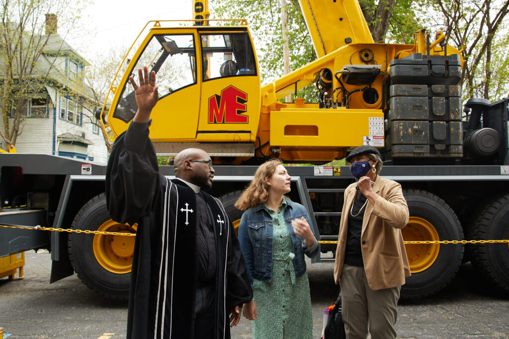 Outside the church, Rev. Kendrick discusses preservation efforts on a spring Sunday in 2023