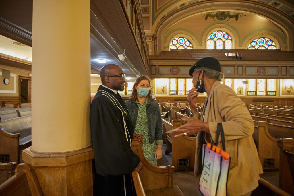 Rev Kendrick engages church community members after Sunday service